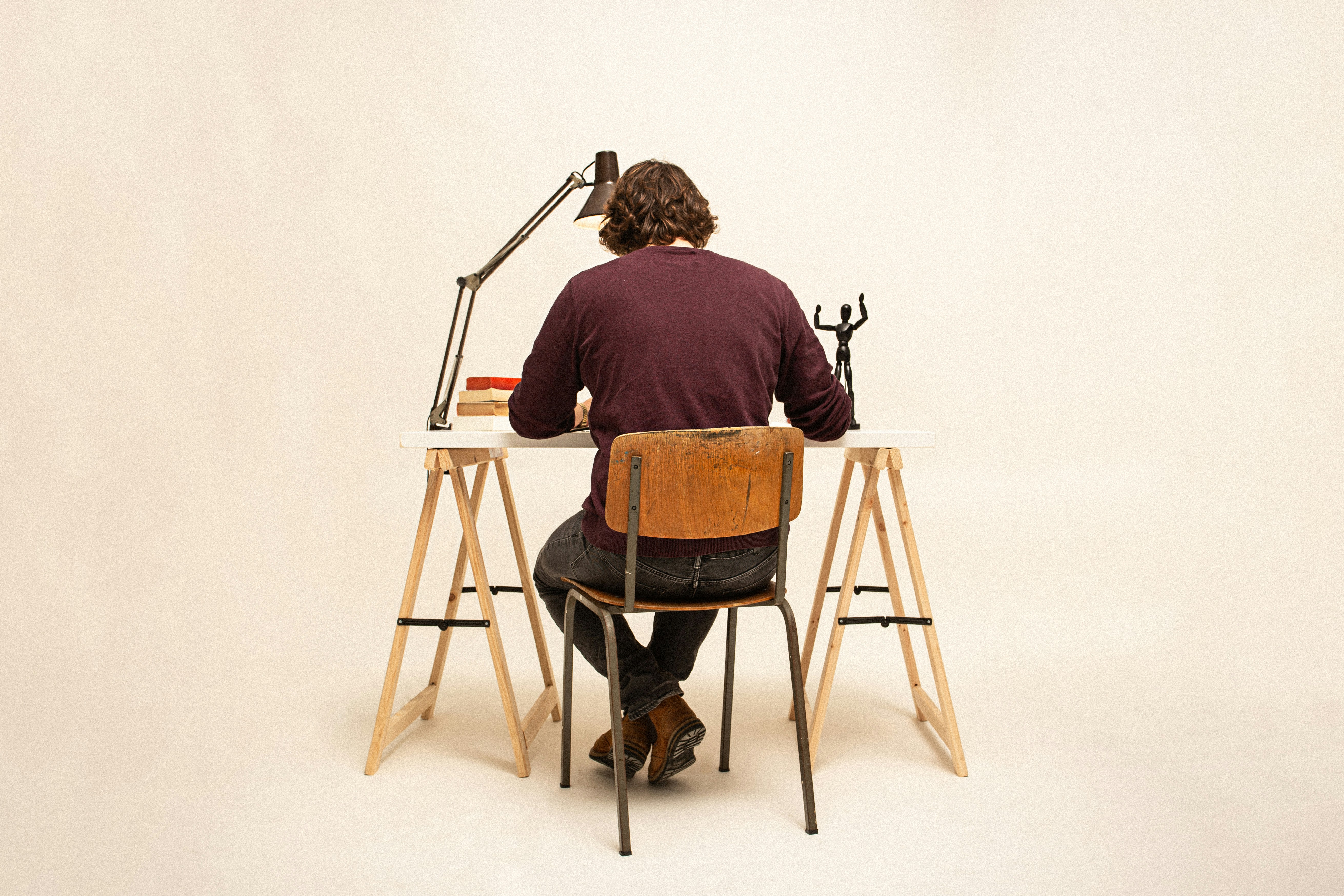 Person working at a desk, relevant to posture while sitting